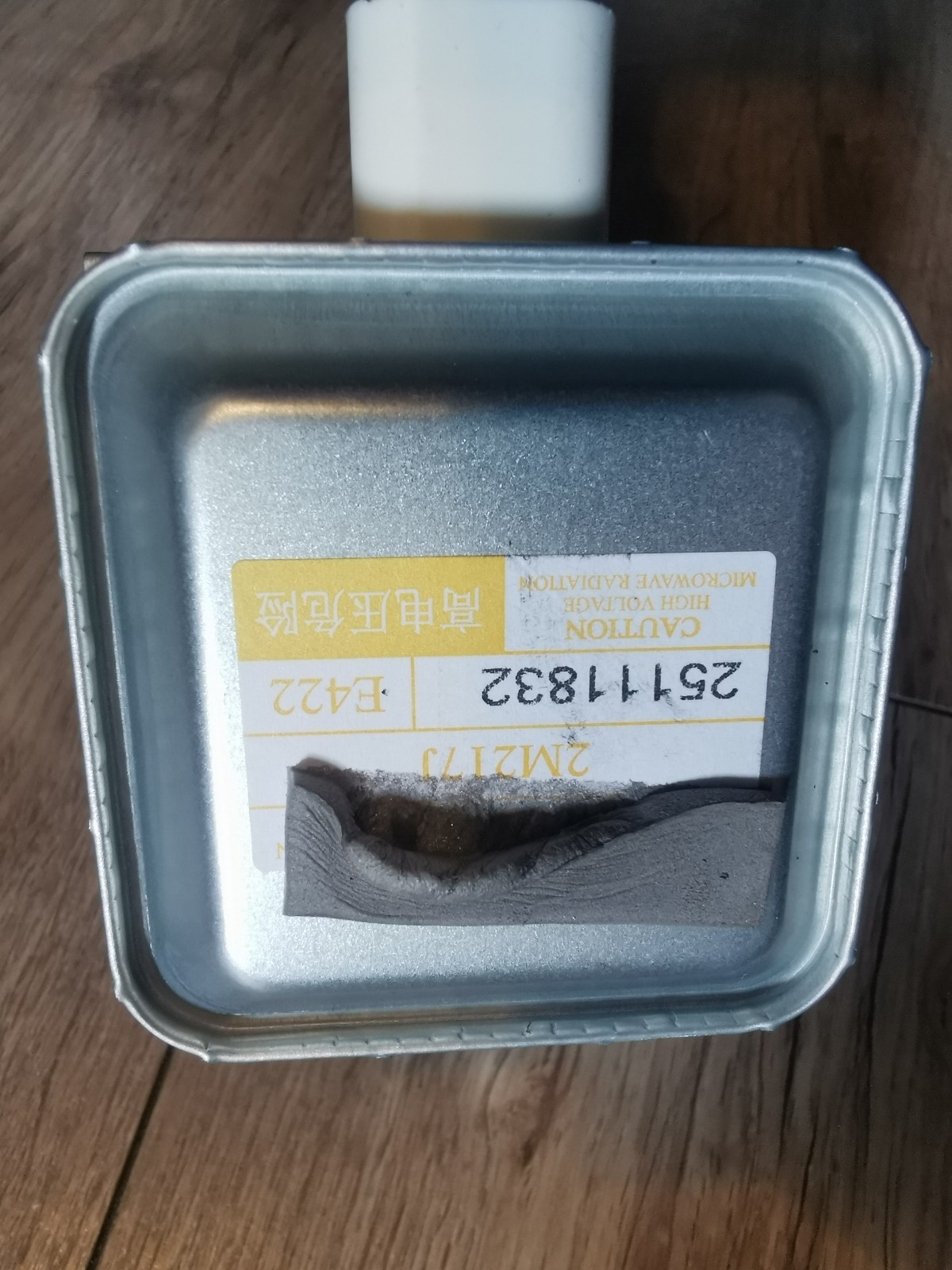 s-l1600-551.jpg Metal rectangular metal can with a white plastic top, yellow caution label about high voltage microwave radiation, and a dented interior.
