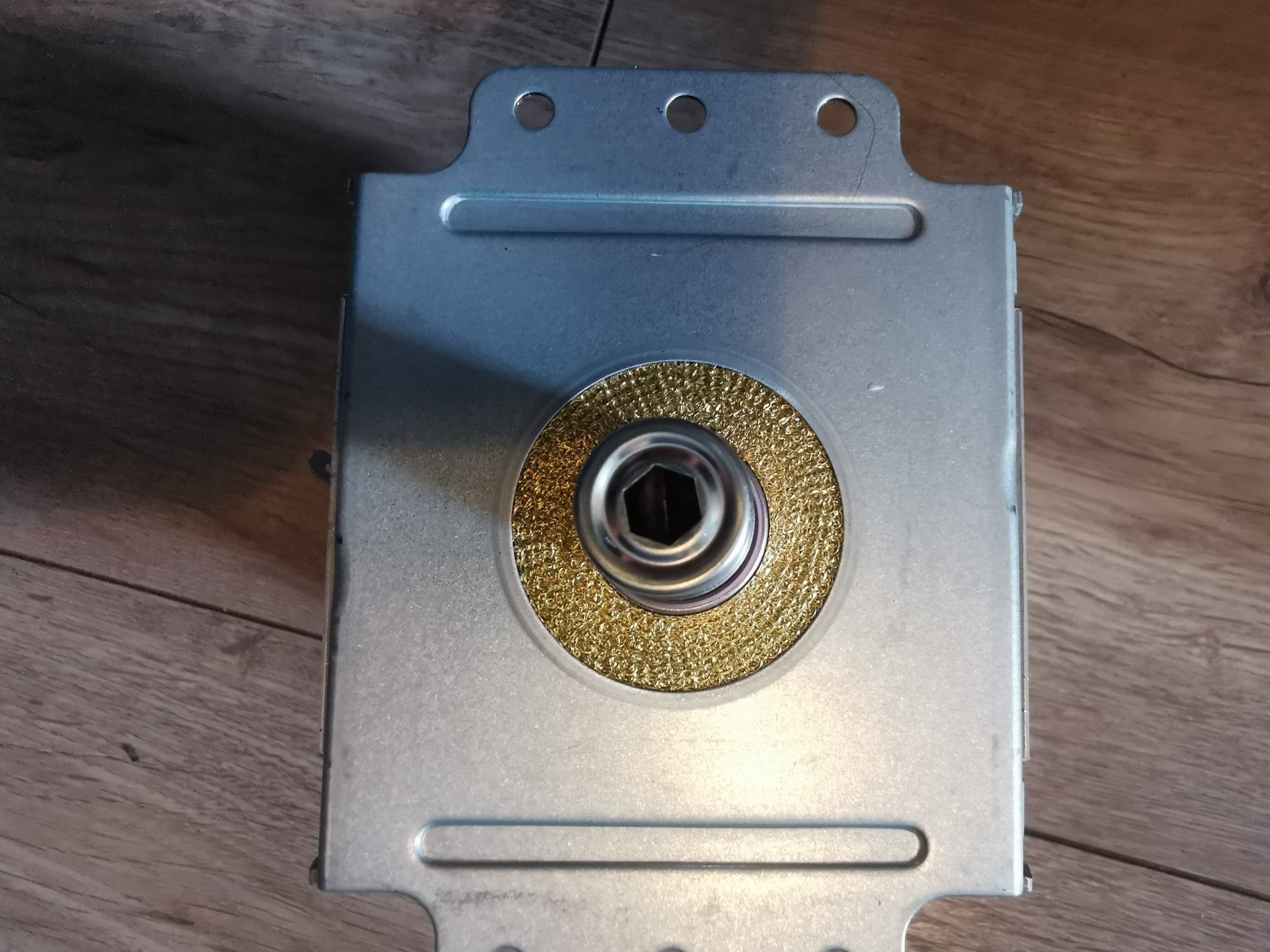 s-l1600-552.jpg Metal electrical box with a gold textured circular hub around a hex drive opening and three top mounting holes in the metal plate.