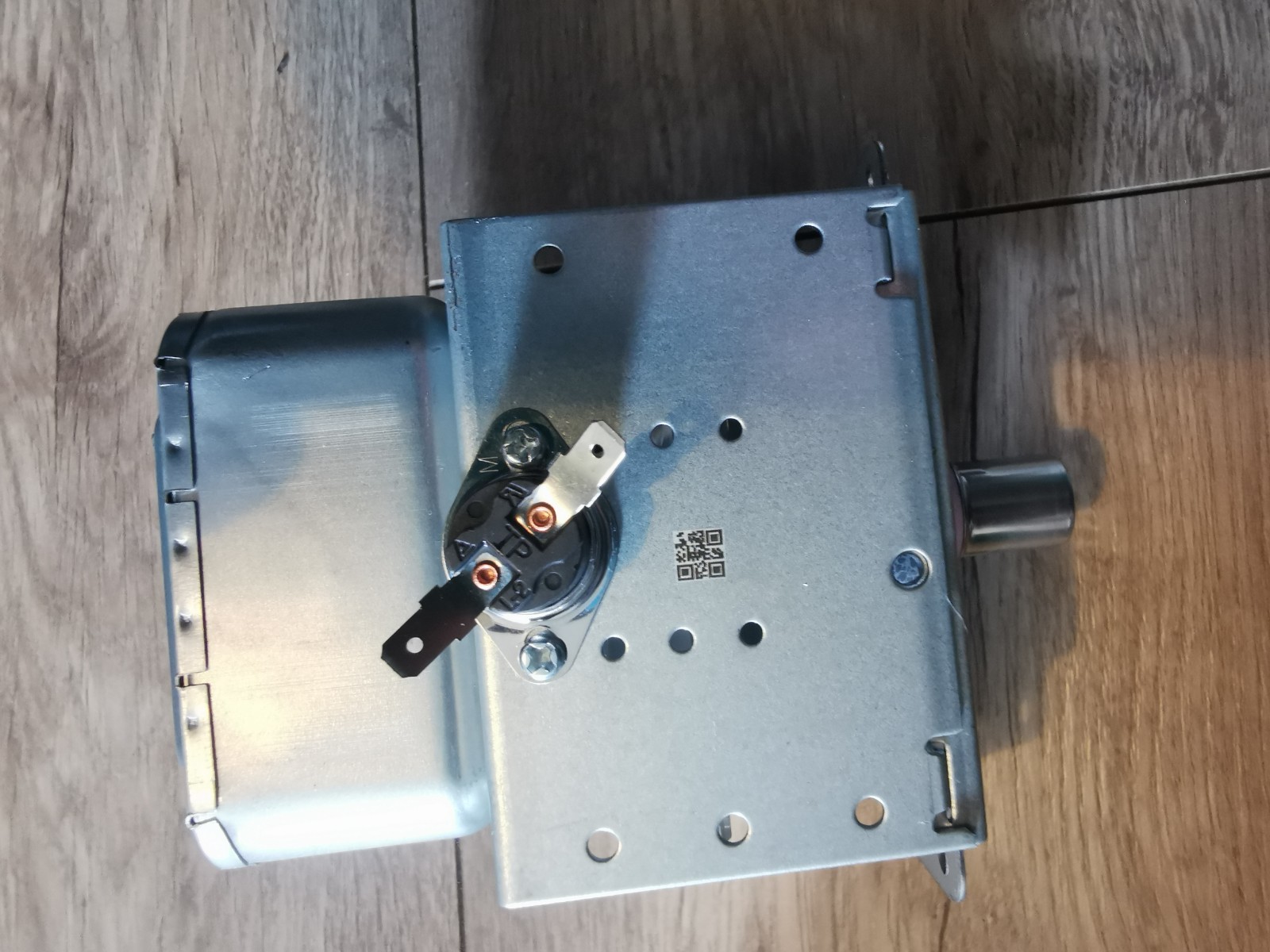 s-l1600-555.jpg Metal electrical enclosure with a circular terminal block and two copper terminal screws mounted on the side, on a wooden surface.