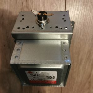 Top view of an LG 2M226 magnetron assembly mounted in a metal housing with terminal contacts visible.