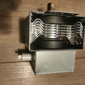 Close-up of a metal relay with stacked zigzag contact springs inside a rectangular housing; brass knob on top.