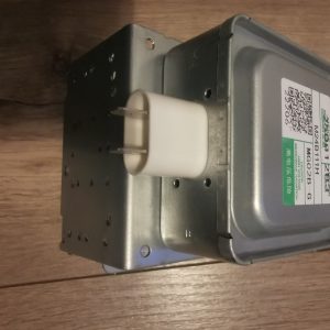 Electrical transformer module with a white ceramic terminal and metal enclosure on a wooden surface