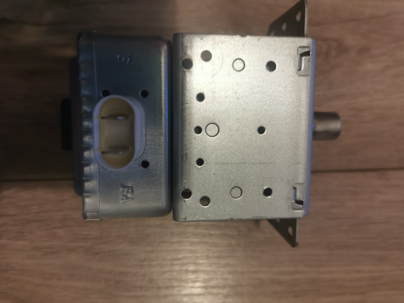 s-l1600-669.jpg Electrical control module with a plastic connector on the left and a perforated metal housing on the right, likely an automotive radio/stereo component.