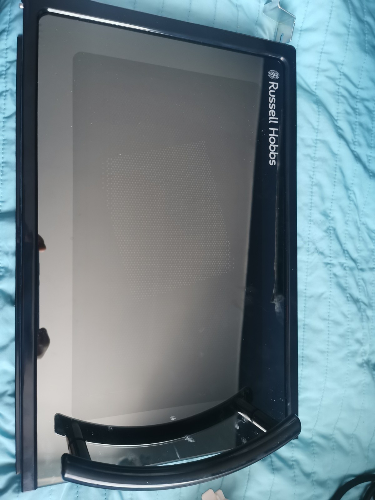 s-l1600-677.jpg Front view of a Russell Hobbs kitchen appliance with a dark frame and touchscreen panel, resting on a blue quilted surface.