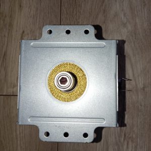 Metal square electrical enclosure with a circular gold ring around a small square-drive shaft at center; multiple mounting holes around the edges.