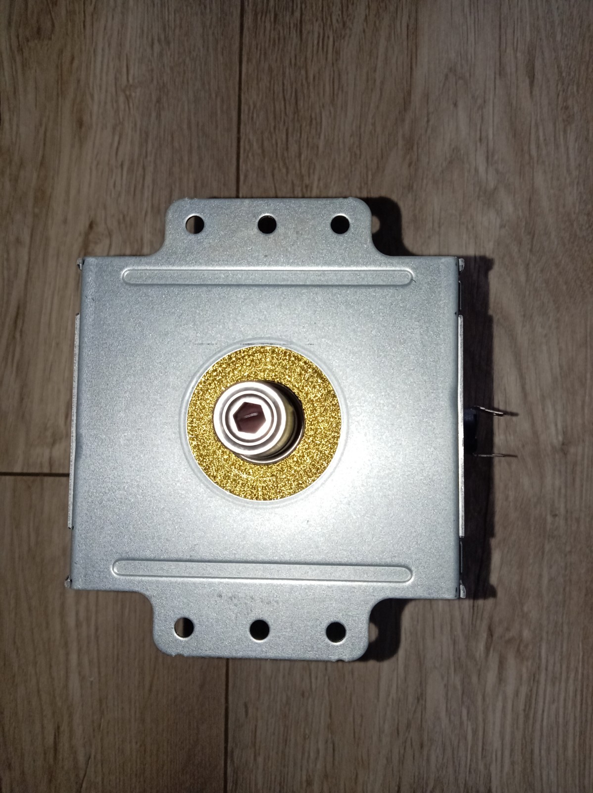 s-l1600-692.jpg Metal square electrical enclosure with a circular gold ring around a small square-drive shaft at center; multiple mounting holes around the edges.
