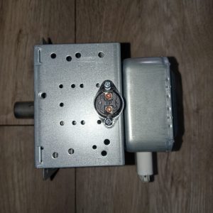 Small DC motor with gearbox mounted on a perforated metal housing, with a circular electrical connector and a white cable nearby.