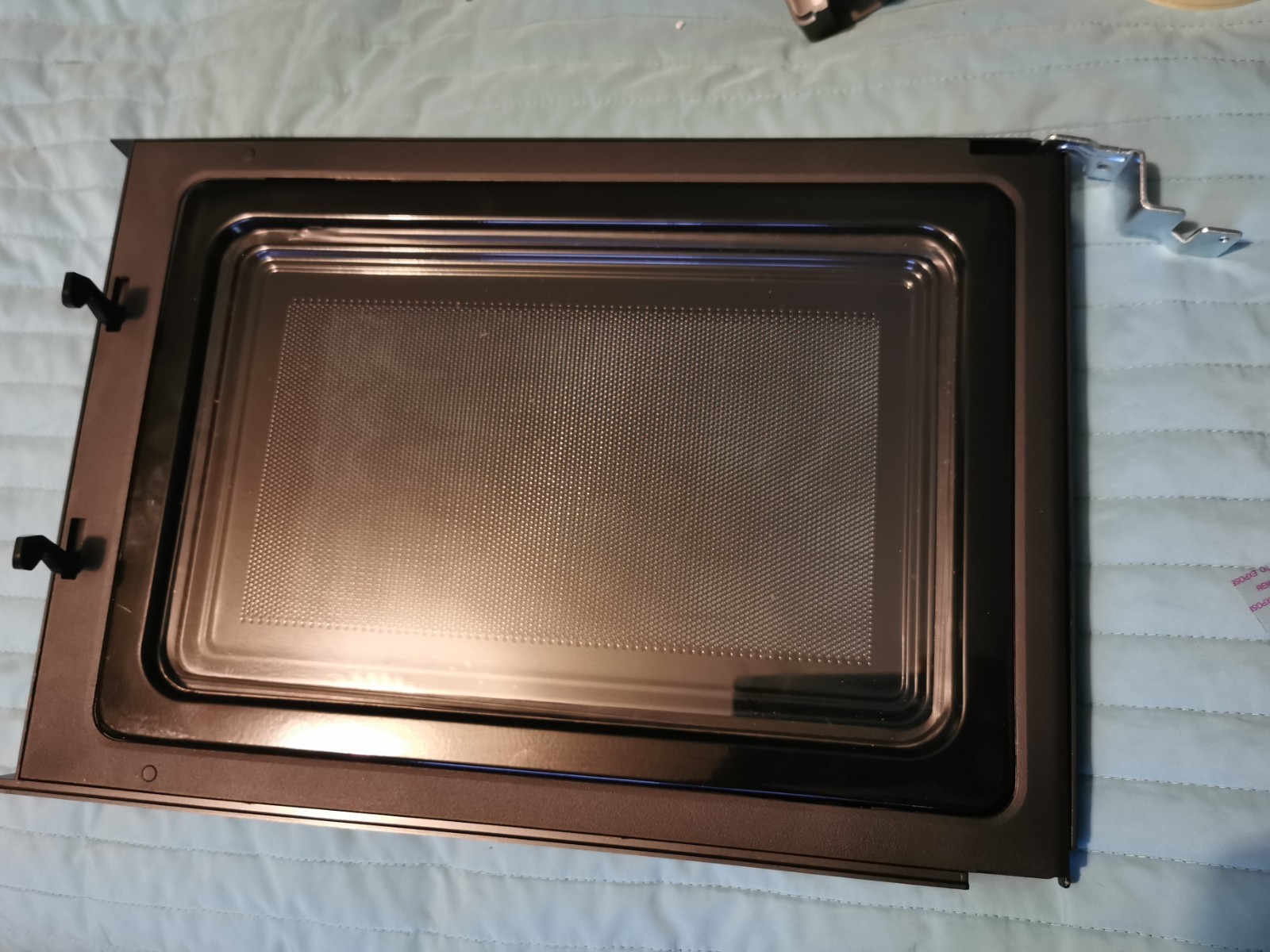 s-l1600-703.jpg Disassembled oven door with inner metal frame and perforated panel on a blue quilt backdrop
