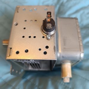 Metal electronic chassis with a small rotary component mounted on top and a drive shaft extending to the right.