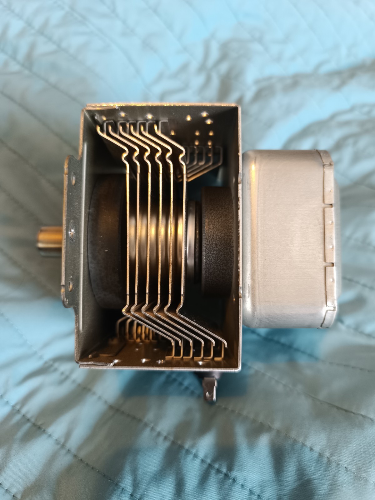 s-l1600-788.jpg Close-up of a small electric motor showing stacked metal laminations and a shaft extending from the left.