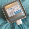 Metallic electrical component with a blue-and-white label reading WITOL, high voltage warning, and Made in China (likely a transformer/relay)