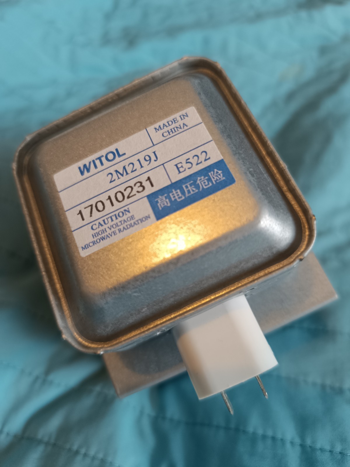 s-l1600-790.jpg Metal high-voltage transformer with a warning label and two pins, likely from a microwave oven.