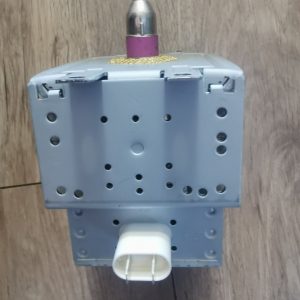 Close-up of a gray electrical device with a purple top knob and metal shaft, showing multiple ventilation holes in the housing.
