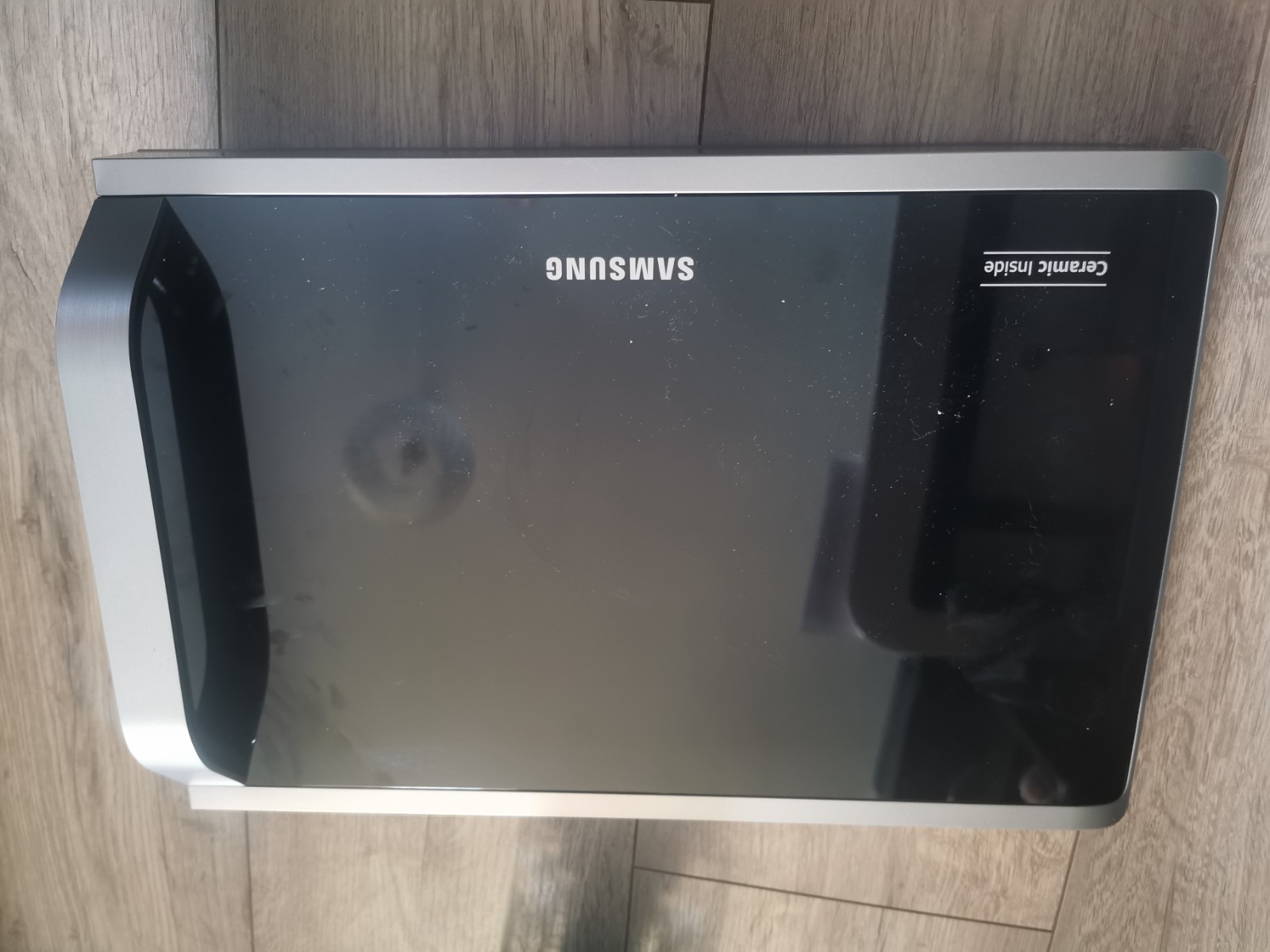 s-l1600-843.jpg Samsung microwave oven with black glass door, silver trim, and Ceramic Inside label on the right side.