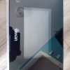Black glossy box with a white Swan logo on the left and a dotted panel graphic, placed on a wooden floor.