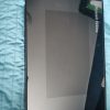 Russell Hobbs tablet-shaped kitchen appliance panel lying on a blue quilted surface, reflective screen facing up