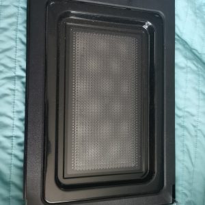 Black rectangular oven tray with a perforated inner insert for catching drips or crumbs (crisping/baking tray).