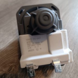 Close-up of a white rotary dimmer switch module with a circular knob and two metal terminals on a wooden surface.