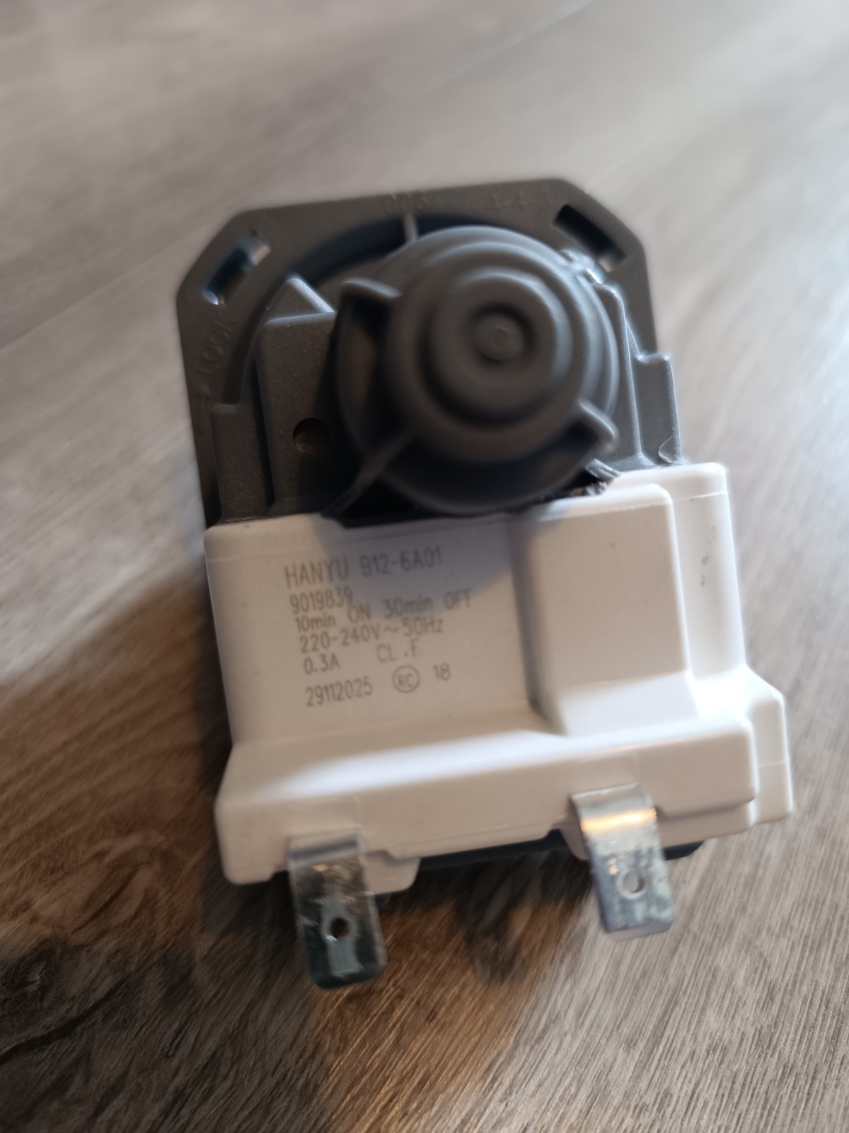 s-l1600-909.jpg Close-up of a white rotary dimmer switch module with a circular knob and two metal terminals on a wooden surface.