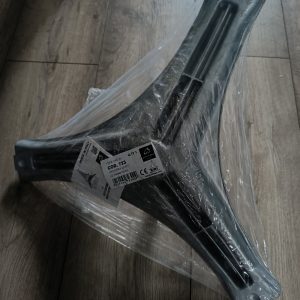 New chair base leg component wrapped in plastic film, ready for assembly.