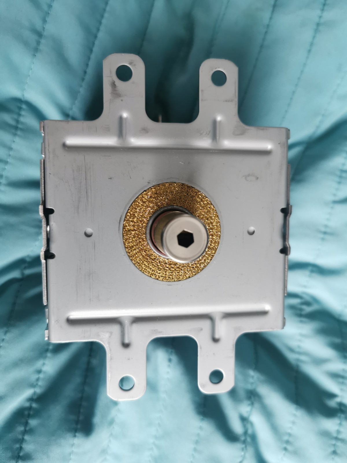 s-l1600-961.jpg Metal electrical component on a gray mounting plate with two top tabs; central brass bushing surrounding a square/hex drive shaft.