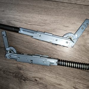 Disassembled semi-automatic pistol parts with recoil springs laid on a wooden surface